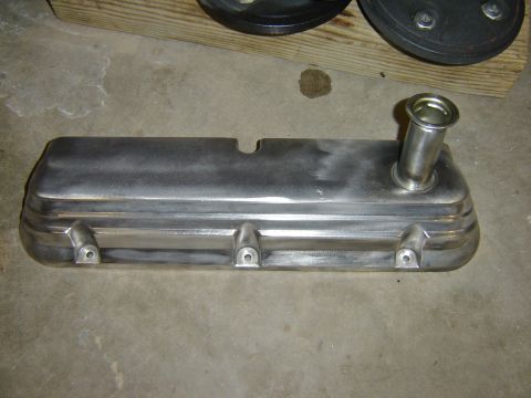 1984 Ford Mustang - A metal valve cover with an oil filler neck is shown on a concrete surface.