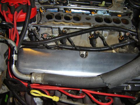 1984 Ford Mustang - Close-up view of an engine bay, showing fuel injectors, spark plug wires, and other engine components.