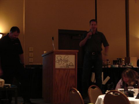 1992 Ford Taurus - A man addresses an audience from behind a wooden podium at an event.