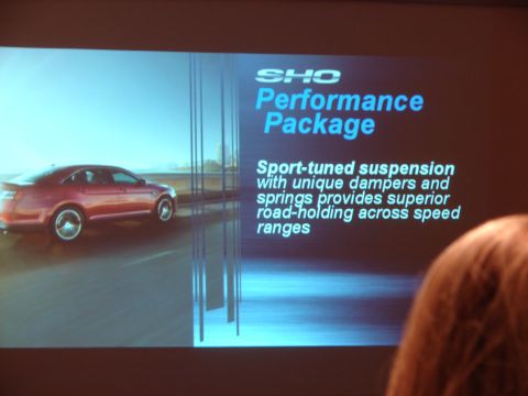 1992 Ford Taurus - A red sedan is displayed with text about its performance package.