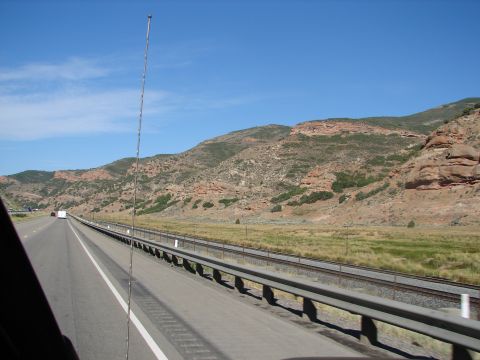 1992 Ford Taurus - View from a vehicle traveling on a highway with mountains in the background.