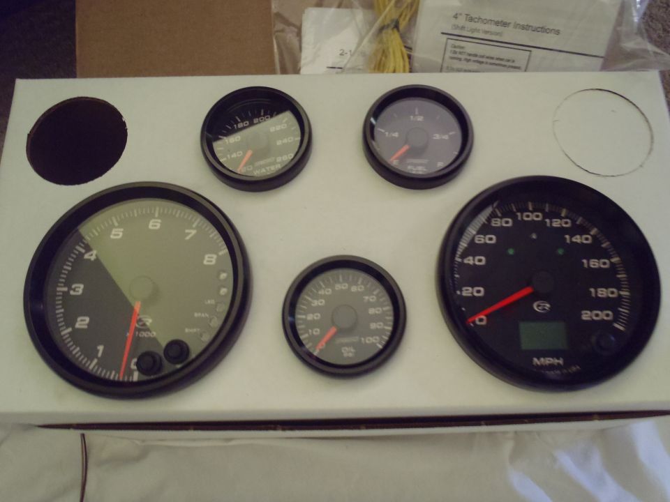 Several dashboard gauges including a tachometer, speedometer, fuel gauge, and oil pressure gauge