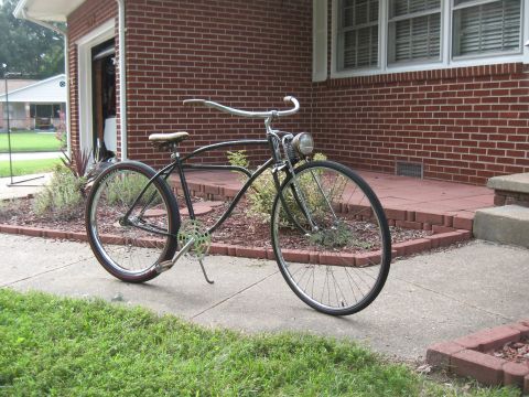 1994 Ford Bronco - A vintage bicycle sits on a sidewalk in front of a brick house.