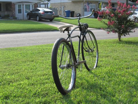 1994 Ford Bronco - A vintage bicycle with a sprung seat and curved handlebars sits on a lawn.