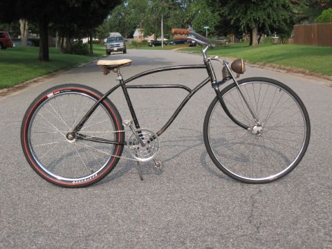 1994 Ford Bronco - A vintage bicycle is parked on an asphalt road in a suburban neighborhood.
