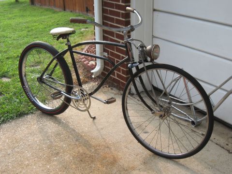 1994 Ford Bronco - A vintage bicycle with a classic frame and chrome handlebars is parked next to a garage door.