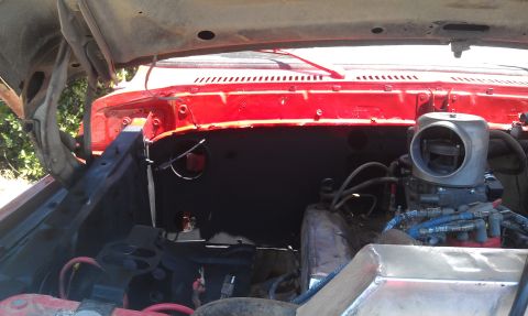 1978 Ford Bronco - Engine bay of a 1978 Ford Bronco, showing the carburetor and red exterior paint.
