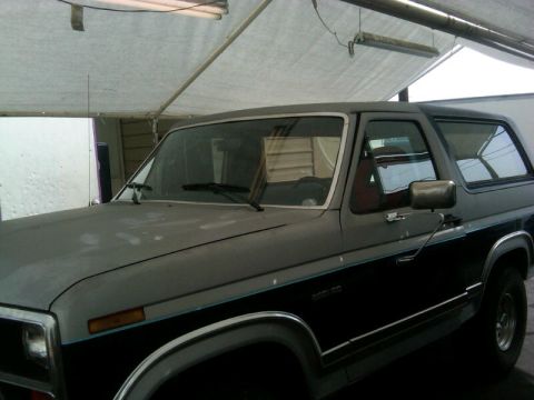 1986 Ford Bronco - Front three-quarter view of a 1986 Ford Bronco parked indoors.