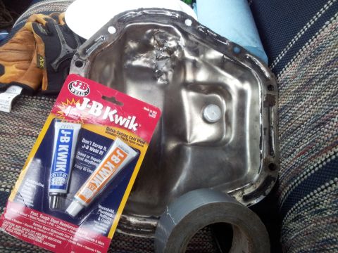 1990 Chevrolet Suburban - Oil pan repair supplies including JB Kwik weld and duct tape.