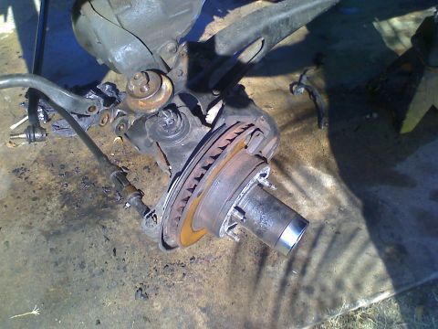 1990 Ford Bronco - Close-up view of a vehicle's front suspension component, including the brake rotor and hub.