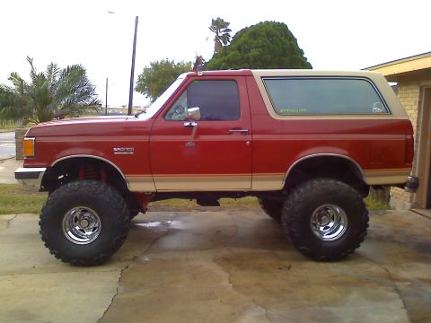 1990 Ford Bronco - This red 1990 Ford Bronco is modified with large off-road tires.