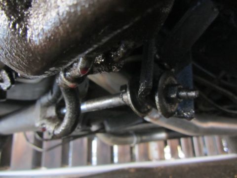 1964 Ford Ranchero - Close-up view of the underside steering mechanism, showing oily components and a drip.