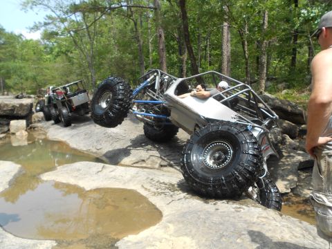 1967 Ford Mustang - Two custom off-road buggies tackle a challenging rocky trail with water obstacles.