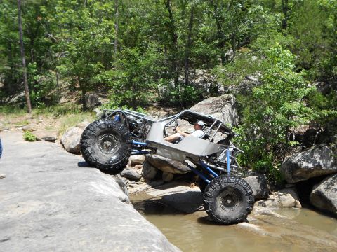 1967 Ford Mustang - A custom-built off-road buggy tackles a challenging rocky stream crossing.