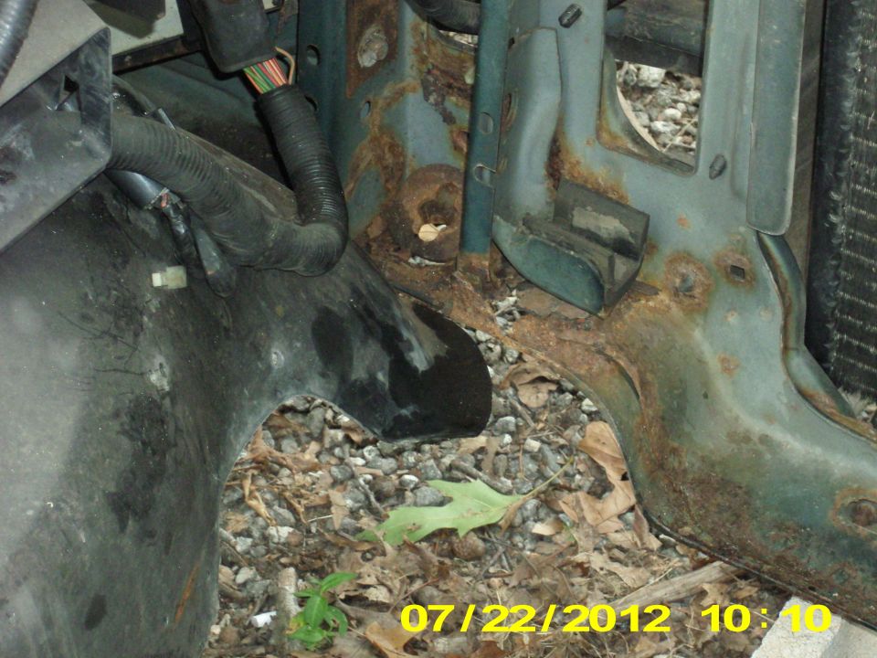 As you see here, this is why the past few months it took a crowbar to pop my hood. I would have to lift up on the left front corner of the hood because the bodymount under the left radiator core support was rotted out so badly. the weight of the radiator put the whole front clip off center, by a half inch or more.
