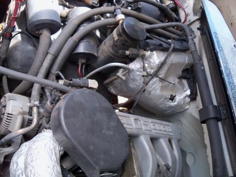 1995 Ford Bronco - Close-up view of a vehicle's engine bay, showing various components and wiring.