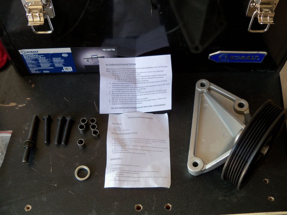 AC removal parts kit with bracket, pulley, bolts, and instructions