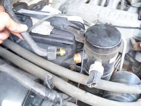 1995 Ford Bronco - This image shows a close-up view of various components within an engine bay.