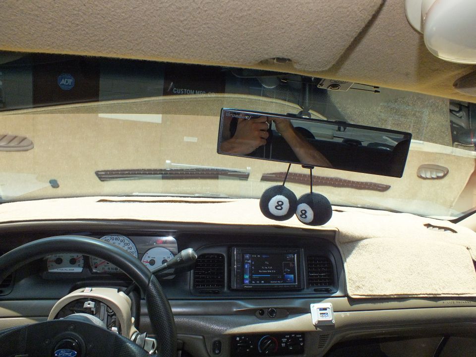 Ford Crown Victoria interior dash with aftermarket gauges, double-DIN stereo and 8-ball mirror hangers