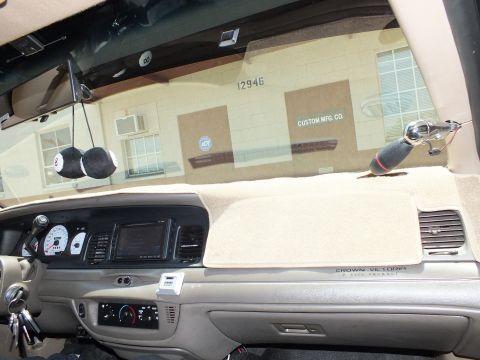 2003 Ford Crown Victoria - Tan dashboard labeled Crown Victoria P-Type Police Package, building reading 12946 outside.