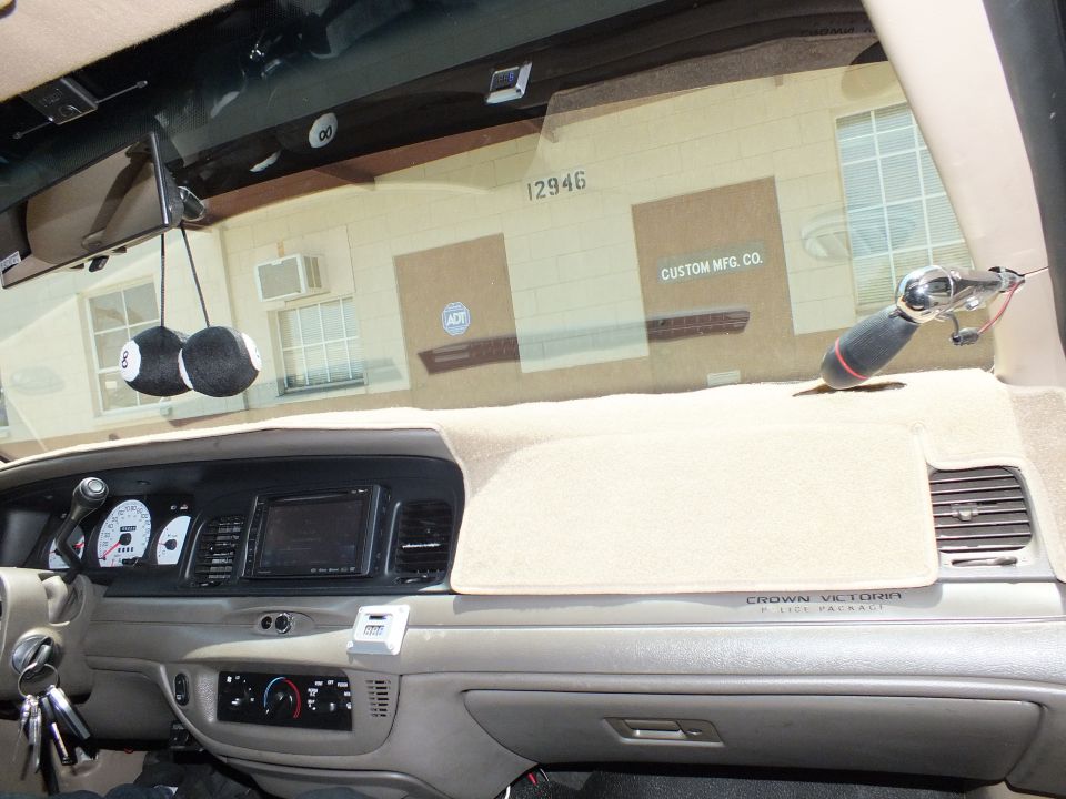 Crown Victoria Police Package dash with tan carpet cover viewed through windshield