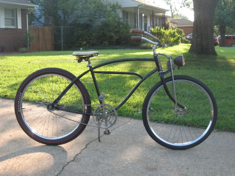 1994 Ford Bronco - Side view of a vintage black cruiser bicycle parked on a sidewalk.