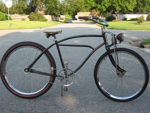 1994 Ford Bronco - A vintage-style bicycle with a classic frame and a single headlight is parked on a suburban street.
