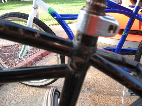 1994 Ford Bronco - Two bicycles are parked outdoors, with a focus on their frame structures and wheels.