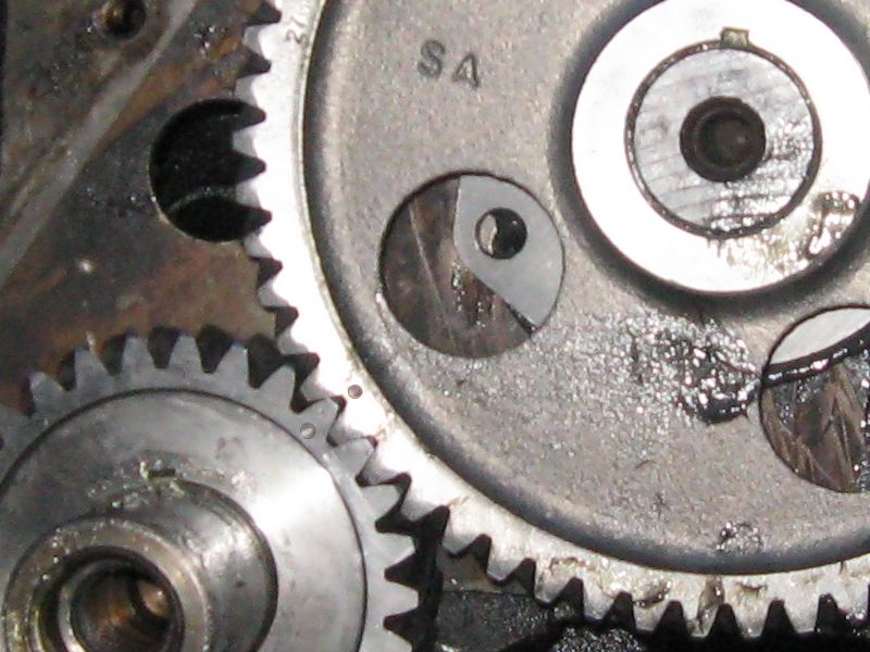 Close-up of engine timing gears with 'SA' marking