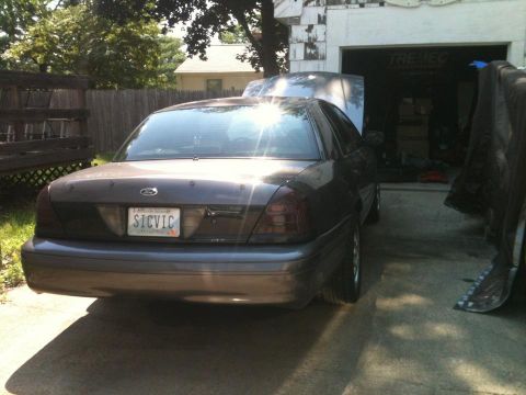 2004 Ford Crown Victoria - 2004 Ford Crown Victoria parked in driveway with hood open.