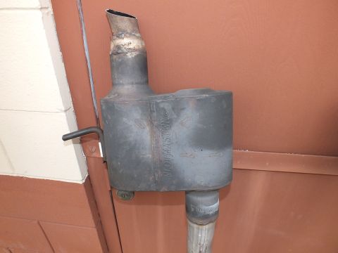 2003 Ford Crown Victoria - Single Flowmaster-style muffler detail showing welded neck and mounting hanger.
