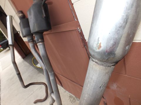 2003 Ford Crown Victoria - Several exhaust pipe sections with bolt flanges and one bright welded tip.
