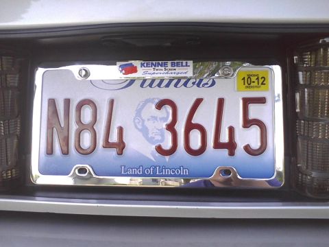 2003 Ford Crown Victoria - Rear view of a vehicle showing an Illinois license plate and a Supercharged sticker.
