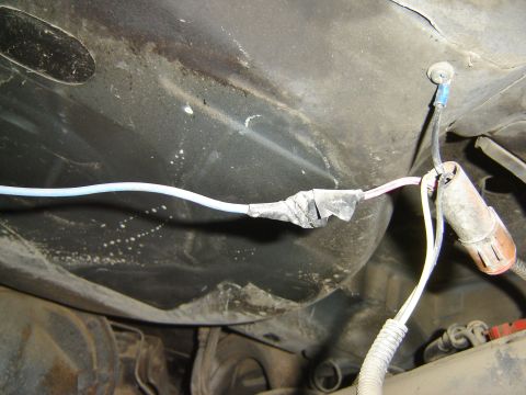 1987 Ford Mustang - A taped automotive wiring harness with connectors is visible in this close-up shot.