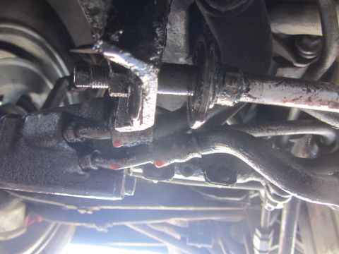 1964 Ford Ranchero - Underside view of a vehicle's steering system, showing oily components and potential leaks.
