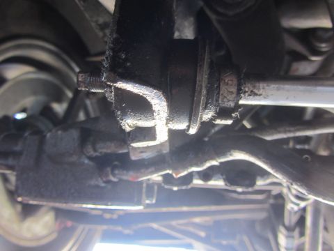1964 Ford Ranchero - Underside view of a vehicle's greasy steering and suspension components, with a partial part number visible.