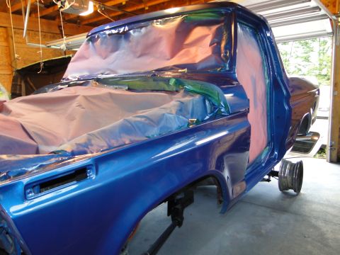 1978 Ford Bronco - Ford Bronco cab and fender masked for painting in a garage.