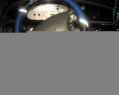 1997 Ford Taurus - Interior shot of a car's dashboard, showing the instrument cluster and steering wheel.