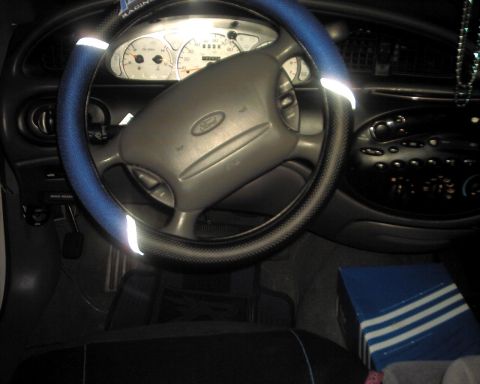 1997 Ford Taurus - Interior view of a 1997 Ford Taurus, showing the steering wheel, dashboard, and center console.