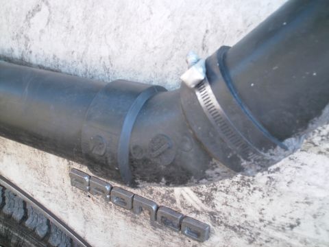 1988 Ford Bronco - PVC 3" 45* bend. Held on the truck with a band clamp with a big rivet through it.