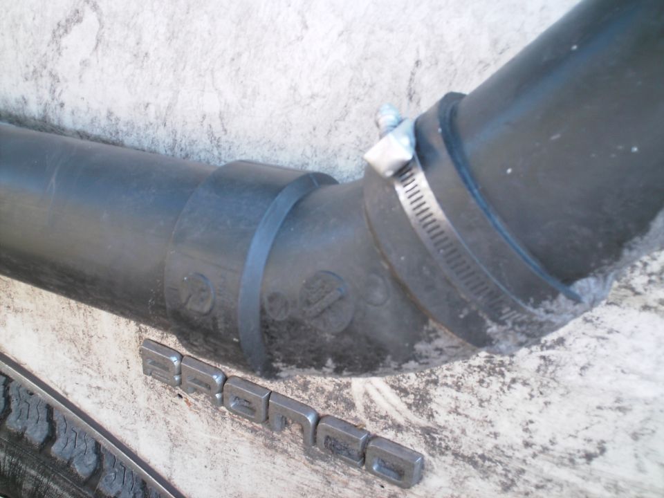 PVC 3" 45* bend. Held on the truck with a band clamp with a big rivet through it.