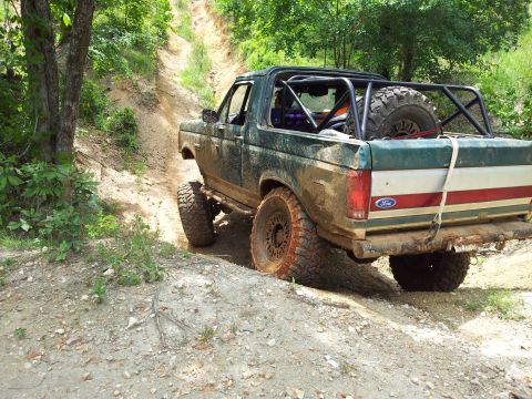 2012 Ford Bronco - This modified Ford Bronco is navigating a challenging off-road trail.