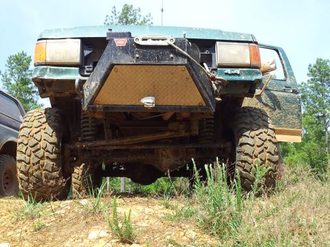 2012 Ford Bronco - This heavily modified green SUV features a prominent winch and oversized tires, suggesting it's built for off-road adventures.