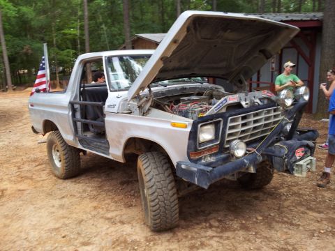 2012 Ford Bronco - This 1978 Ford Bronco features off-road modifications and an American flag displayed in the bed.