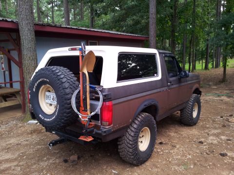 2012 Ford Bronco - Rear view of a Ford Bronco equipped for off-roading with a spare tire and recovery gear.