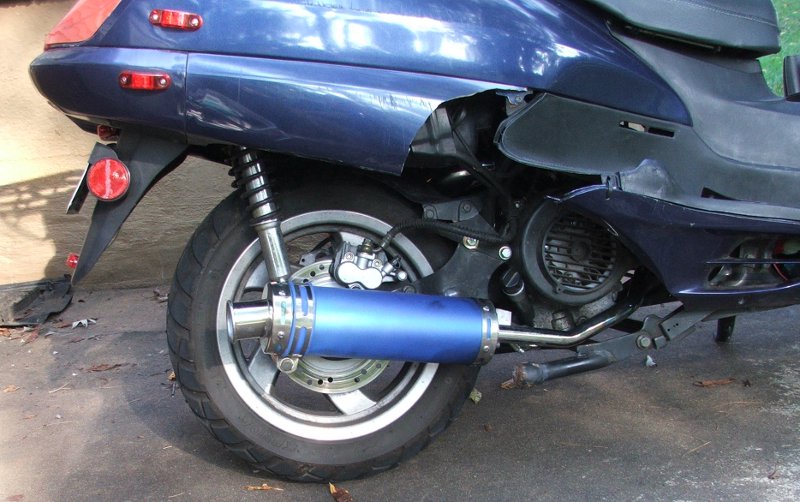 Blue scooter rear with blue anodized aftermarket exhaust, disc brake and panels removed
