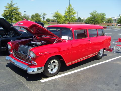 2007 Ford Mustang - Classic red Chevrolet station wagon on display, hood raised to show the engine compartment.