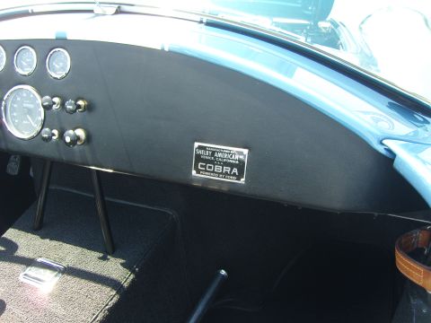 2007 Ford Mustang - The dashboard features several gauges and a plaque indicating 'Shelby American Cobra Powered by Ford'.