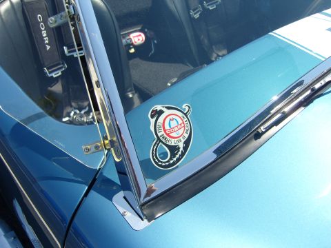 2007 Ford Mustang - A sticker for the Cobra Owners Club of America is visible on the hood of a blue car.