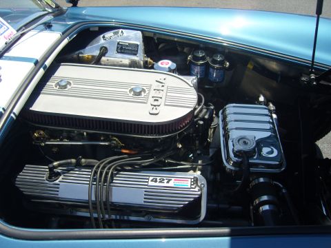 2007 Ford Mustang - The engine bay of a blue car displays a prominent "427 COBRA" engine with a large air cleaner.